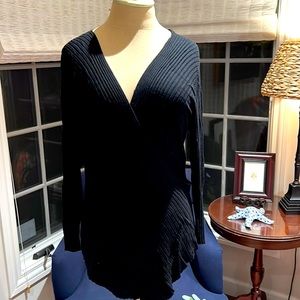 Black ribbed knit sweater with low v-neck. Size medium.